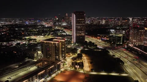 Lit Office Tower and Expressway in Uptown Dallas at Night Stock Footage 343068964