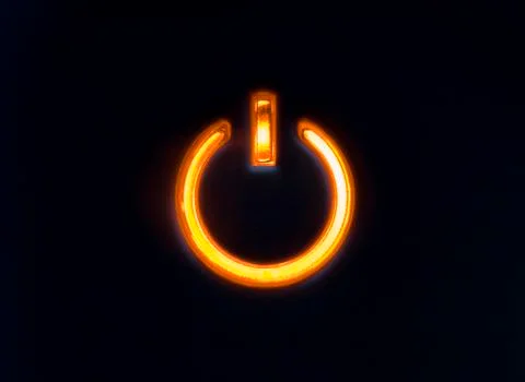 Lit power button in orange color Stock Photos