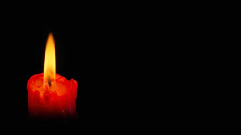 Lit red candle on black background. Stock Footage 303836123
