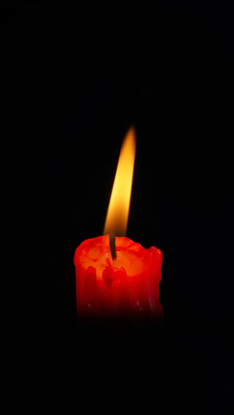 Lit red candle on black background. Stock Footage 303836476