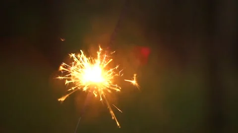 Lit Sparkler making nice warm fiery sparks. Celebrating Christmas, New Years Stock Footage 139767775