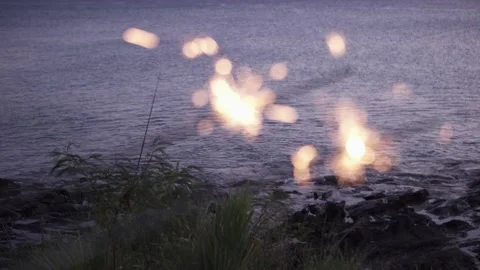 Lit sparklers in front of ocean. Stock Footage 135232367