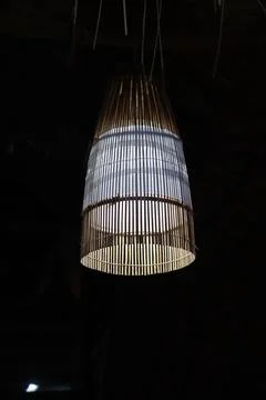 Lit from within, the lamp features a construction from bamboo, emitting light Stock Photos