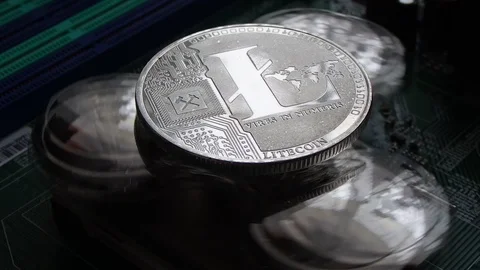 Litecoin Crypto Currency, rotating mirror surface, computer motherboard. Stock Footage 87871912