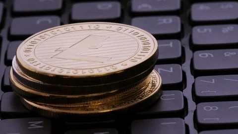Litecoin mining. Cryptocurrency on laptop keyboard Stock Footage 86389133