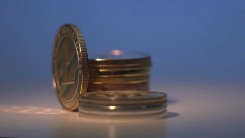 Litecoin is rotating on the black surface surrounded by another gold cryptocoins Stock Footage 129932629