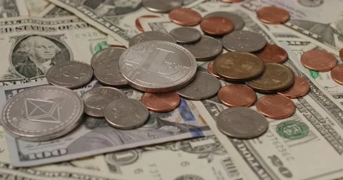 Litecoin on top of US Dollar banknotes and coins. Cryptocurrency LTC with USD Stock Footage 172486469