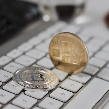 Litecoin on the white keyboard Stock Photos