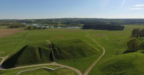 Lithuania Kernave ciltural reserve ancient mounds by river aerial Stock-Footage 75697908