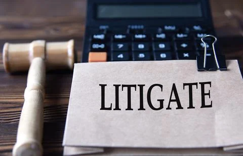 LITIGATE - word on light brown paper against the background of a calculator.. Stock Photos