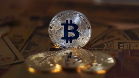 Liting moving around silver bitcoin and euro currency. Stock Footage 104192953