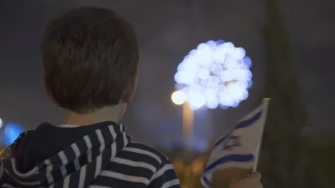Litle boy looking at fireworks and Waving Israeli Flag, 스톡 동영상 108081339