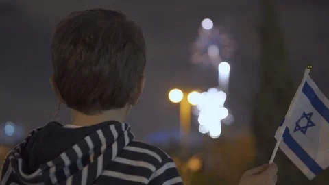 Litle boy looking at fireworks and Waving Israeli Flag, 스톡 동영상 108088012