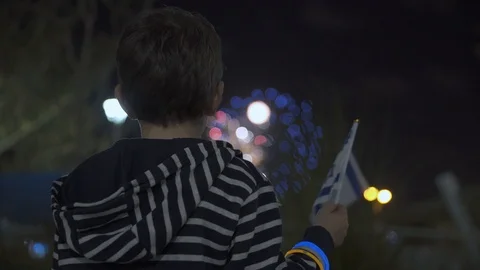 Litle boy looking at fireworks and Waving Israeli Flag, 스톡 동영상 108089665