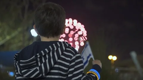 Litle boy looking at fireworks and Waving Israeli Flag, 스톡 동영상 108090403