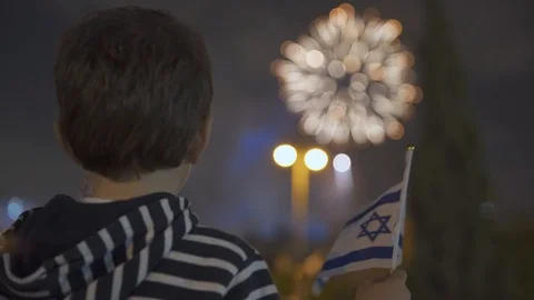 Litle boy looking at fireworks and Waving Israeli Flag, 스톡 동영상 108093456