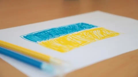 Litle child hand draws the flag of Ukraine Stock Footage 172572209