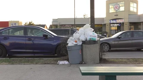 Litter and garbage cans overflowing pile up during COVID 19 pandemic Stock Footage 151674572