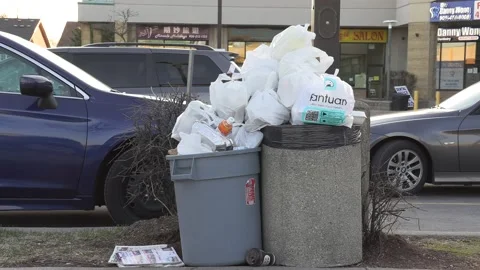 Litter and garbage cans overflowing pile up during COVID 19 pandemic Stockbeeldmateriaal 151675353