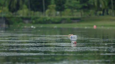 Litter floating on the river surface Stock Footage 254191364
