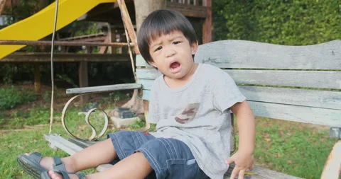 Little 2 year boy playing in outdoor playground Stock Footage 137434619