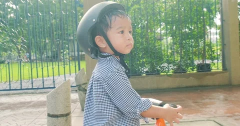 Little 2 year boy playing balance bike in tree park outdoor Stock Footage 142251627
