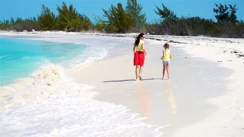 Little adorable girl and young mother at tropical beach. Family of two have a Stock Footage