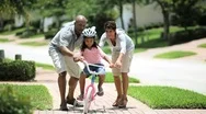 Little African American Girl Learning To Ride A Bike Stock Footage