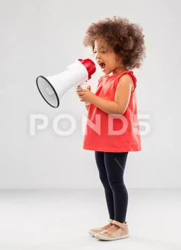 Little african american girl shouting to megaphone Stock Photos