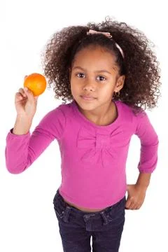 Little African Asian girl holding a tangerine Stock Photos