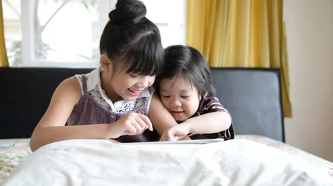 Little asian children using tablet while on bed Stock Footage 49450695