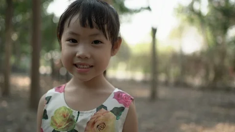 Little asian girl smiling and looking at camera. Stock Footage