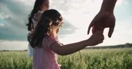 Little Asian Girl Walking On The Green Field With Their Parents, Holding Hands Stock Footage