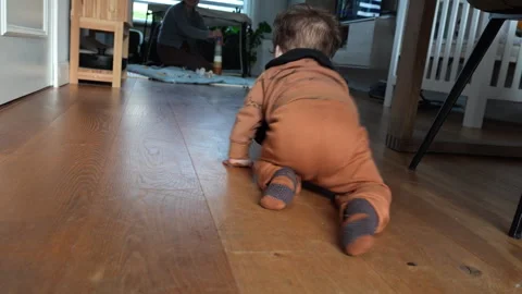 Little baby boy playfully crawling towards his mother in the living room. Stock Footage 301427341