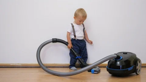 Little baby child work with vacuum clean... | Stock Video | Pond5