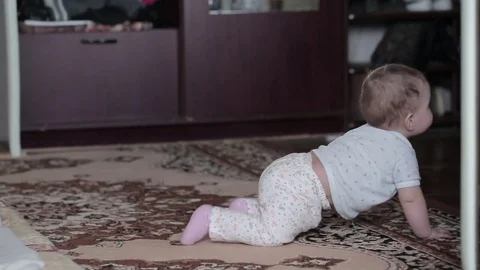 Little baby crawling on the floor at home Stock Footage