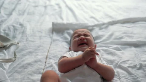 Little baby is crying on bed Stock Footage 202073015