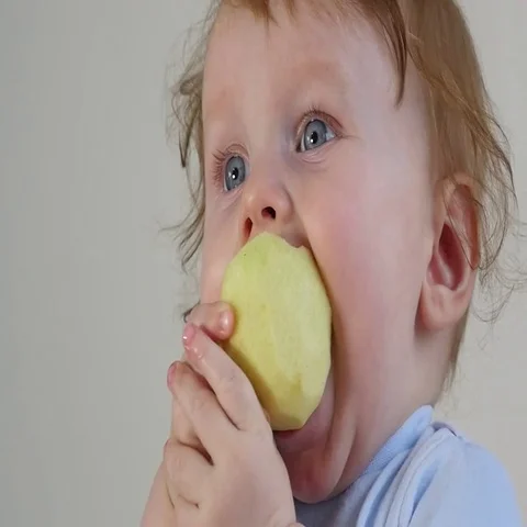 Little Baby Eating Apple Stock Footage