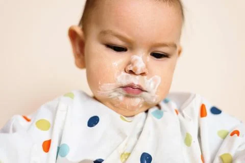 A Little baby eating her dinner and making a mess Stock Photos