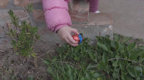 Little baby found easter egg in garden Stock Footage 54073641