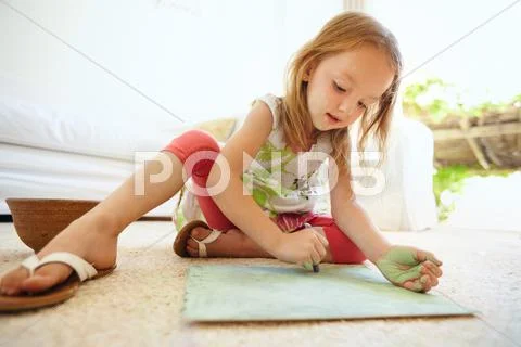 Little baby girl coloring picture at home Stock Photos