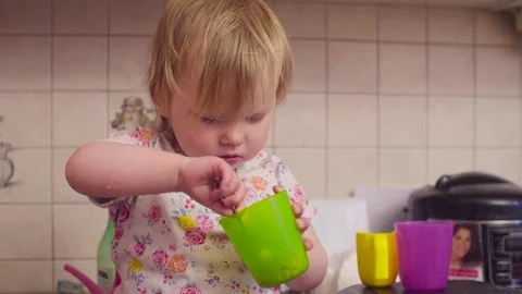 Little baby girl eating something Stock Footage