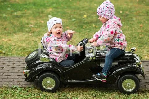 The little baby girl playing at car Stock Photos