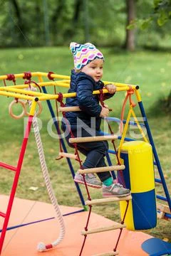 The little baby girl playing at outdoor playground Stock Photos