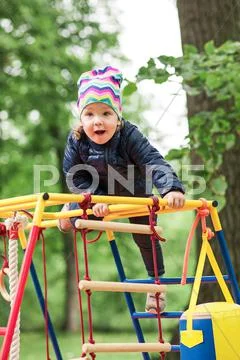 The little baby girl playing at outdoor playground Stock Photos