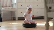 Little Baby Girl Rolling On Moving Robot Vacuum Cleaner While Cleaning Home Stock Footage