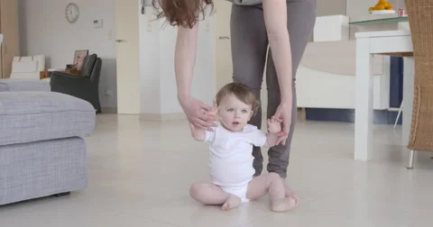 Little baby having fun learning to stand by mum hand Stock Footage 56063344