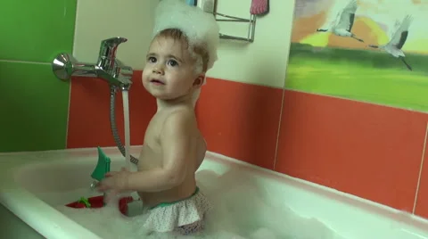 Funny little baby girl in the bath playi. Stock Video Pond5