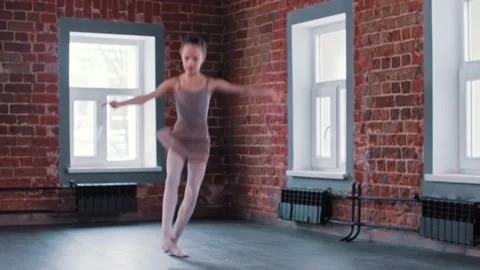 A little ballerina girl performing basic dancing in the studio Stock Footage 154137445