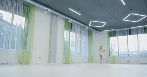 Little ballerina in tutu performs classical dance in light studio Stockbeeldmateriaal 141022244